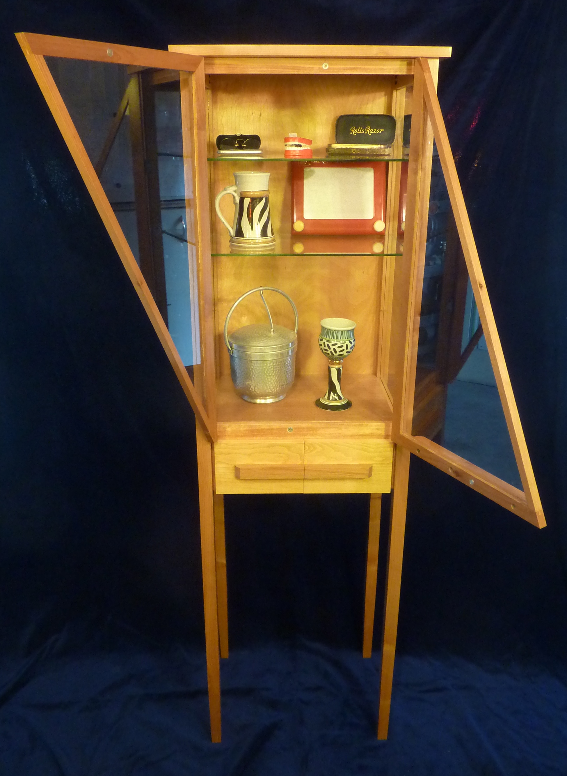 Display cabinet with glass doors open